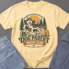 Yellow t-shirt with a husky dog relaxing in a camping chair and text "Dog Parent Social Club."