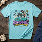 Light blue t-shirt with cartoon dog and "Camp Zoomie Outdoor Chaos Program" text.