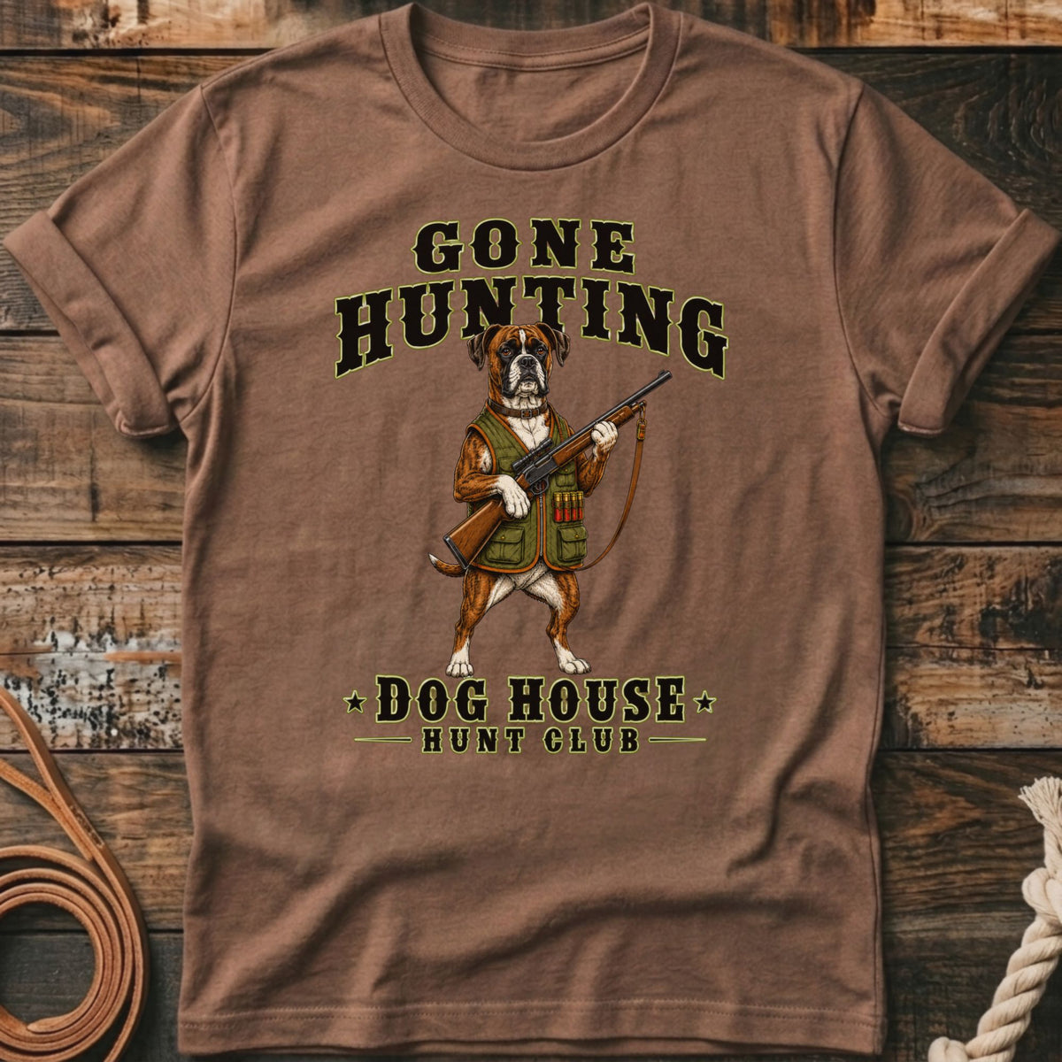 Brown t-shirt with a boxer dog graphic holding a rifle, "Gone Hunting" and "Dog House Hunt Club" text.