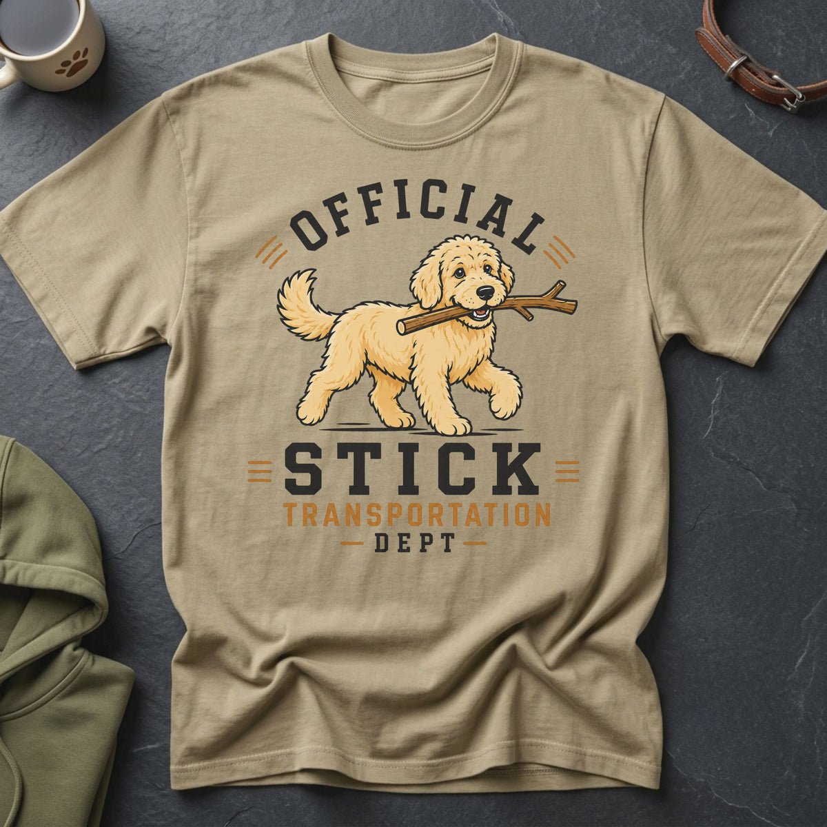 T-shirt graphic featuring a cartoon dog holding a stick and text "Official Stick Transportation Dept".