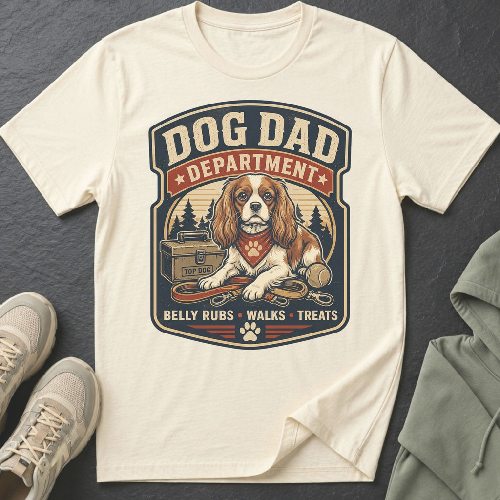 Cream t-shirt with "Dog Dad Department" graphic featuring a dog, leash, and tennis ball.