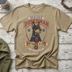 Tan t-shirt with a Doberman dog graphic that says "Rescued Doberman Loyalty Club Adopted Protector."