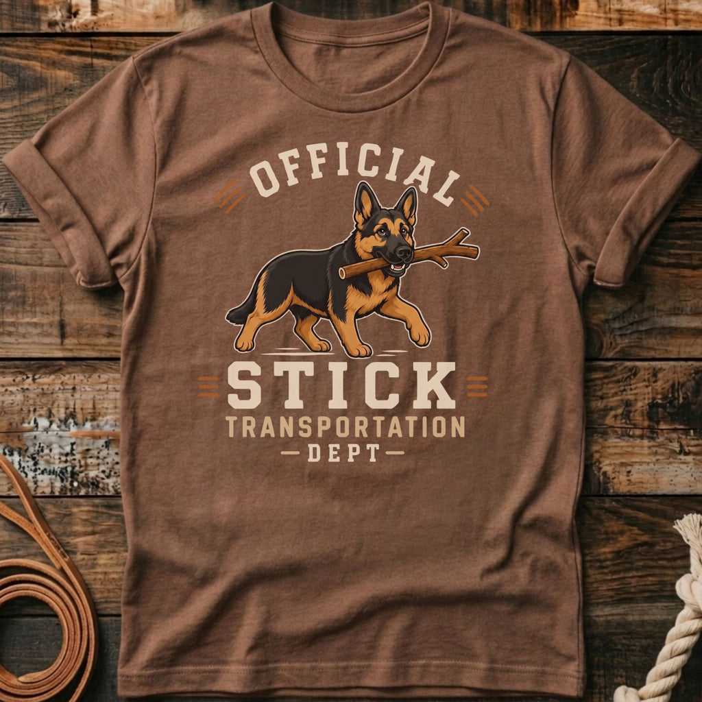 German Shepherd with stick on shirt reading "Official Stick Transportation Dept".