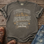 Gray t-shirt with "I Work Hard So My Dog Can Ignore Me In Comfort Club Zoomie" text.