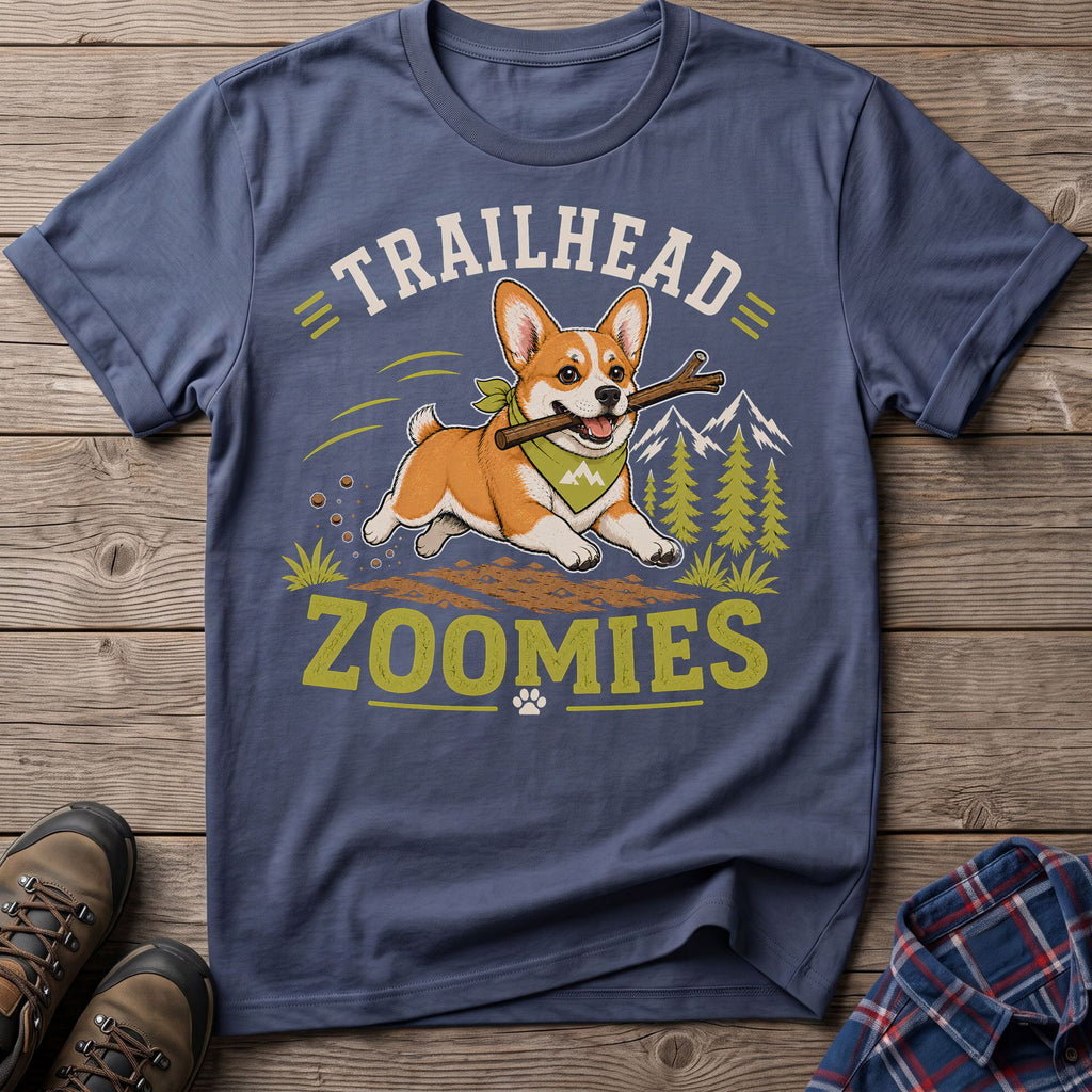 Corgi with a stick runs through mountains, with text "TRAILHEAD ZOOMIES".
