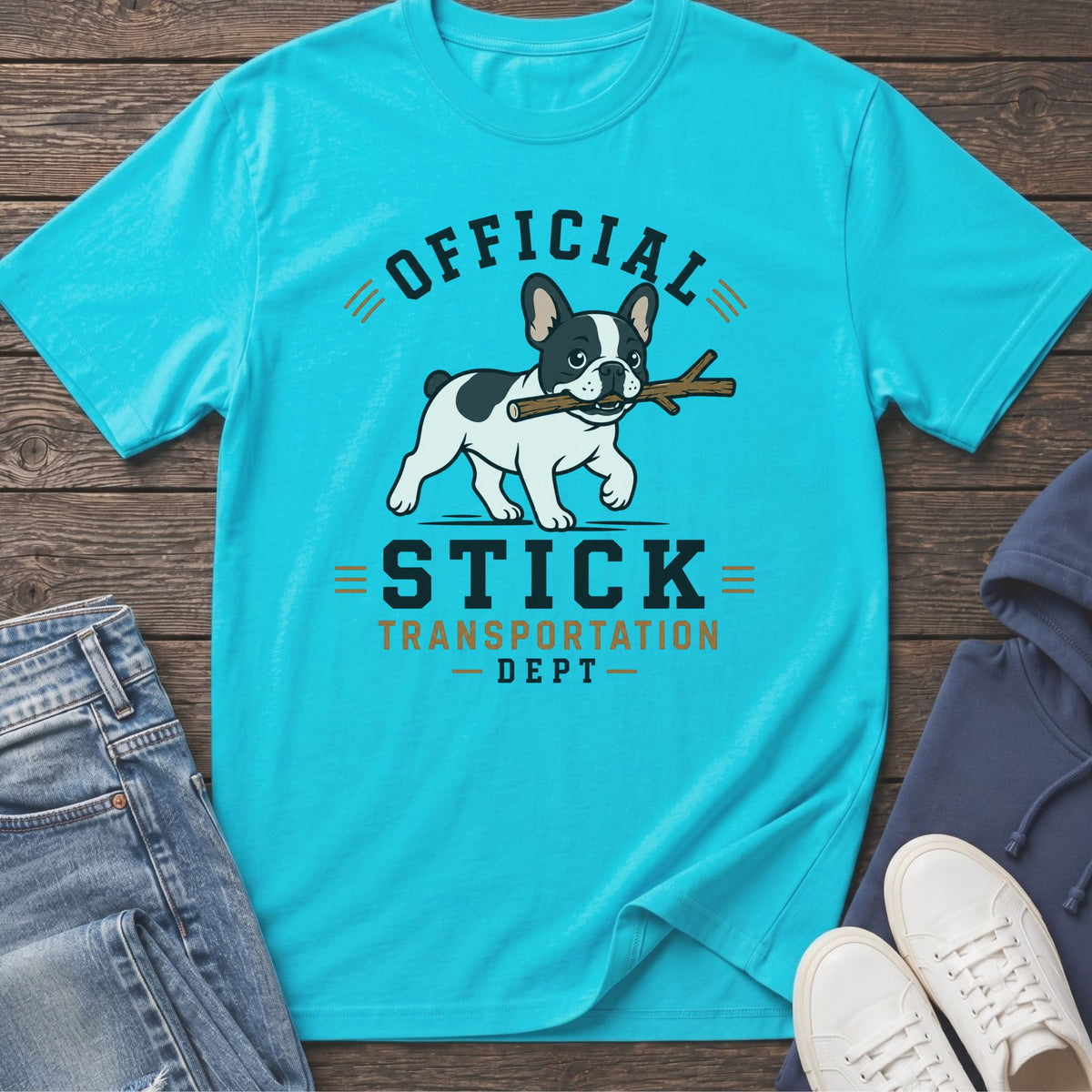 Turquoise t-shirt with "Official Stick Transportation Dept." text and French bulldog carrying a stick.