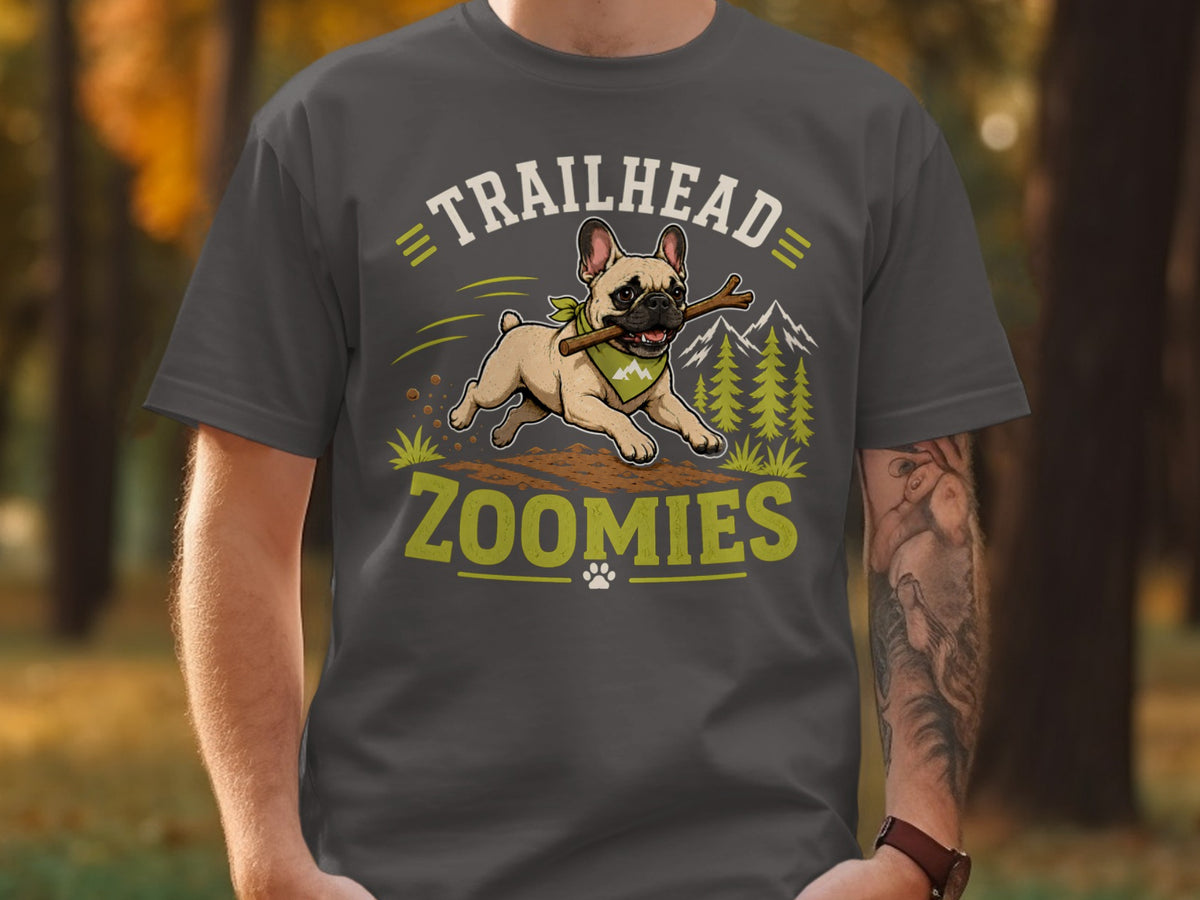 French bulldog with stick runs through dirt path, text "TRAILHEAD ZOOMIES".