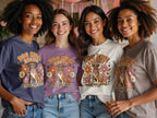 Four women in different colored shirts display a retro graphic of a boxer dog and flowers.