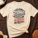 Cream t-shirt with "Club Zoomie, No Brakes. No Recall." graphic.