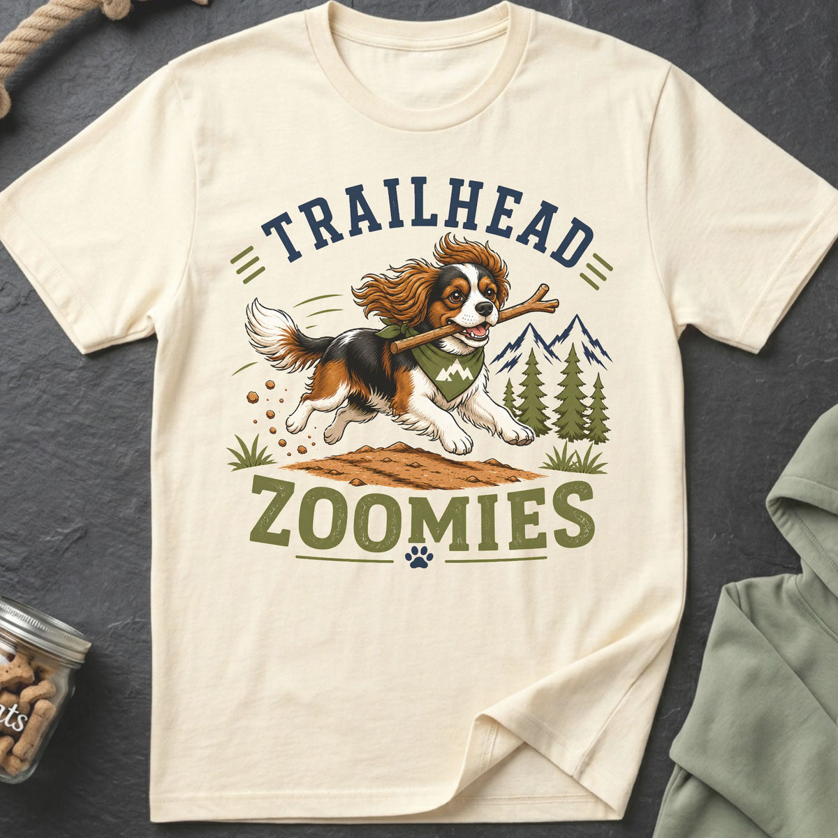 Cream t-shirt with dog running with stick, text "TRAILHEAD ZOOMIES".