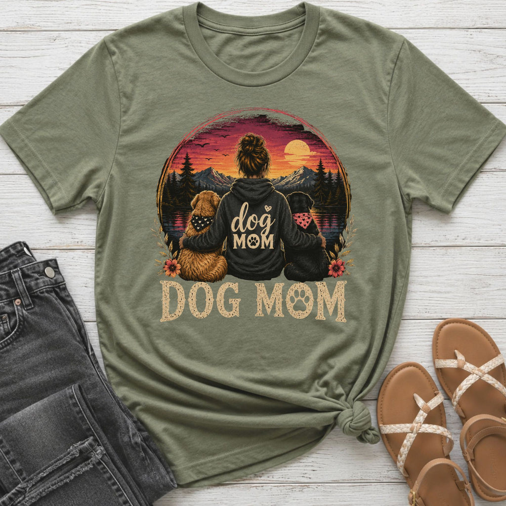 Olive green t-shirt with "Dog Mom" graphic featuring woman and dogs at sunset.