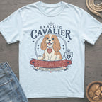 Light blue t-shirt with a Cavalier King Charles Spaniel graphic and text.