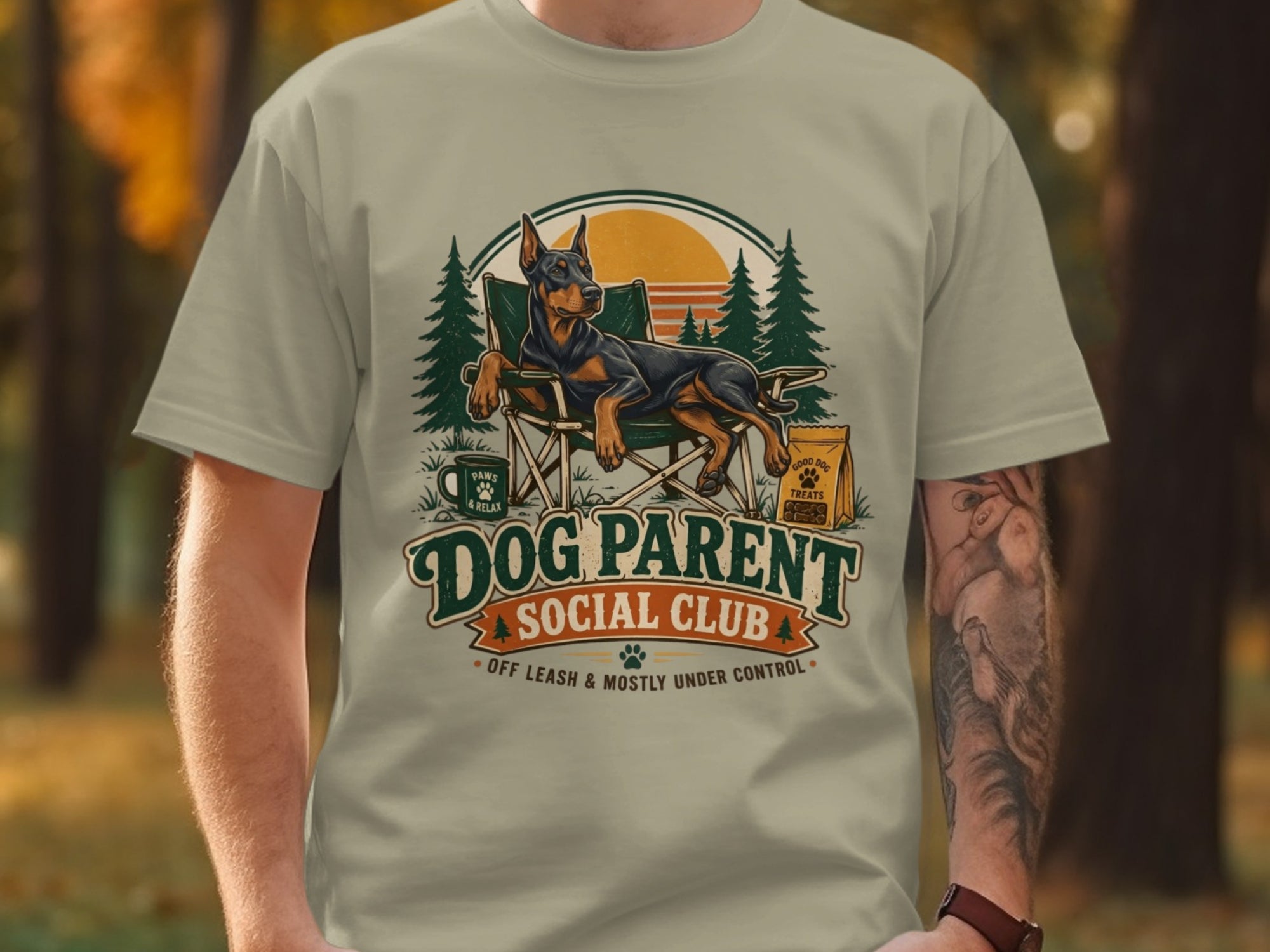 Doberman dog in camping chair with "Dog Parent Social Club" text.
