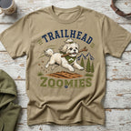 Tan t-shirt with "Trailhead Zoomies" text and a white dog holding a stick.