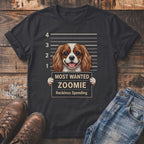 T-shirt graphic: Cavalier King Charles Spaniel mugshot reading "Most Wanted Zoomie Reckless Speeding".
