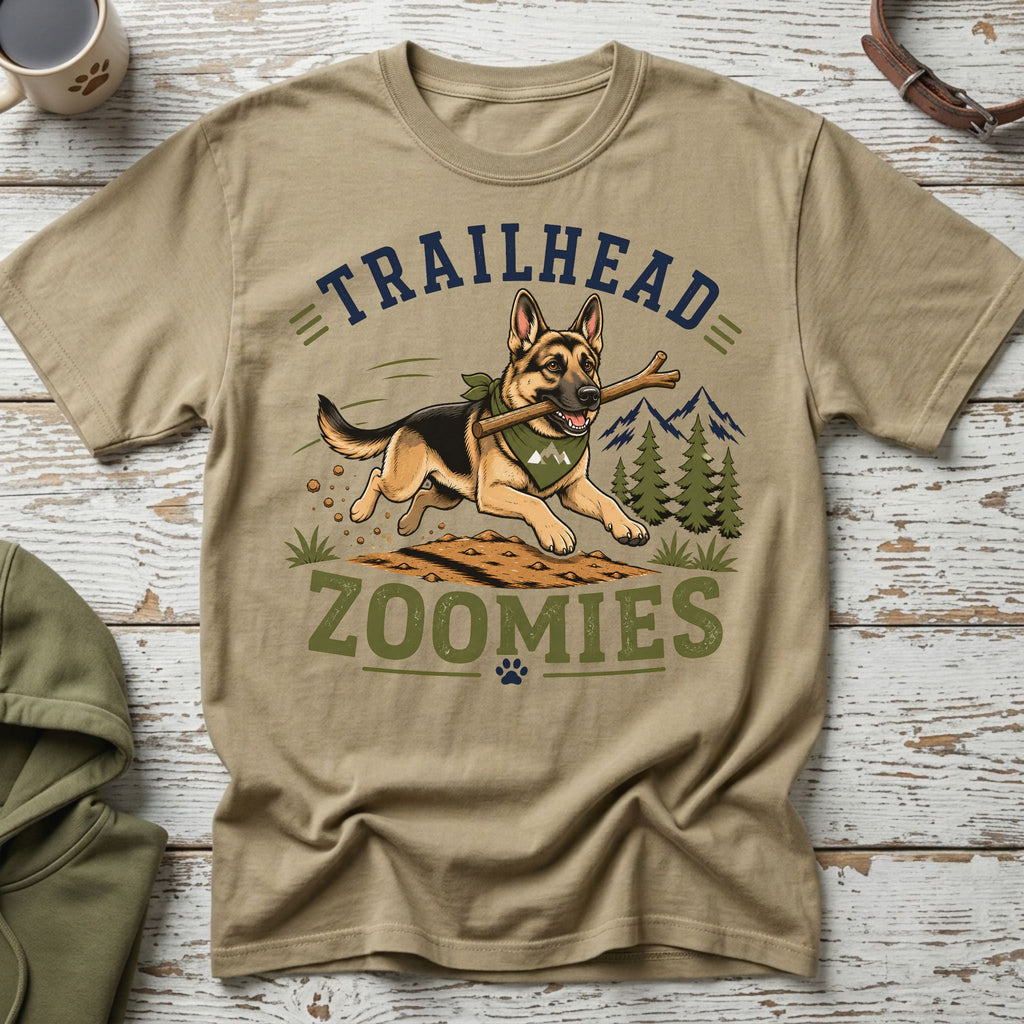 German Shepherd with stick on t-shirt reading "Trailhead Zoomies" with mountains and trees.