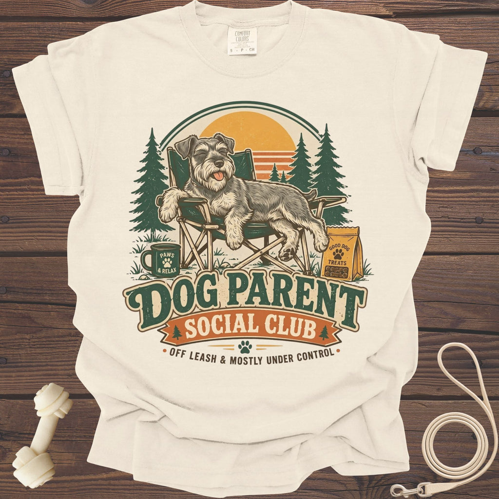 T-shirt graphic with a dog lounging in a camping chair, "Dog Parent Social Club" text.