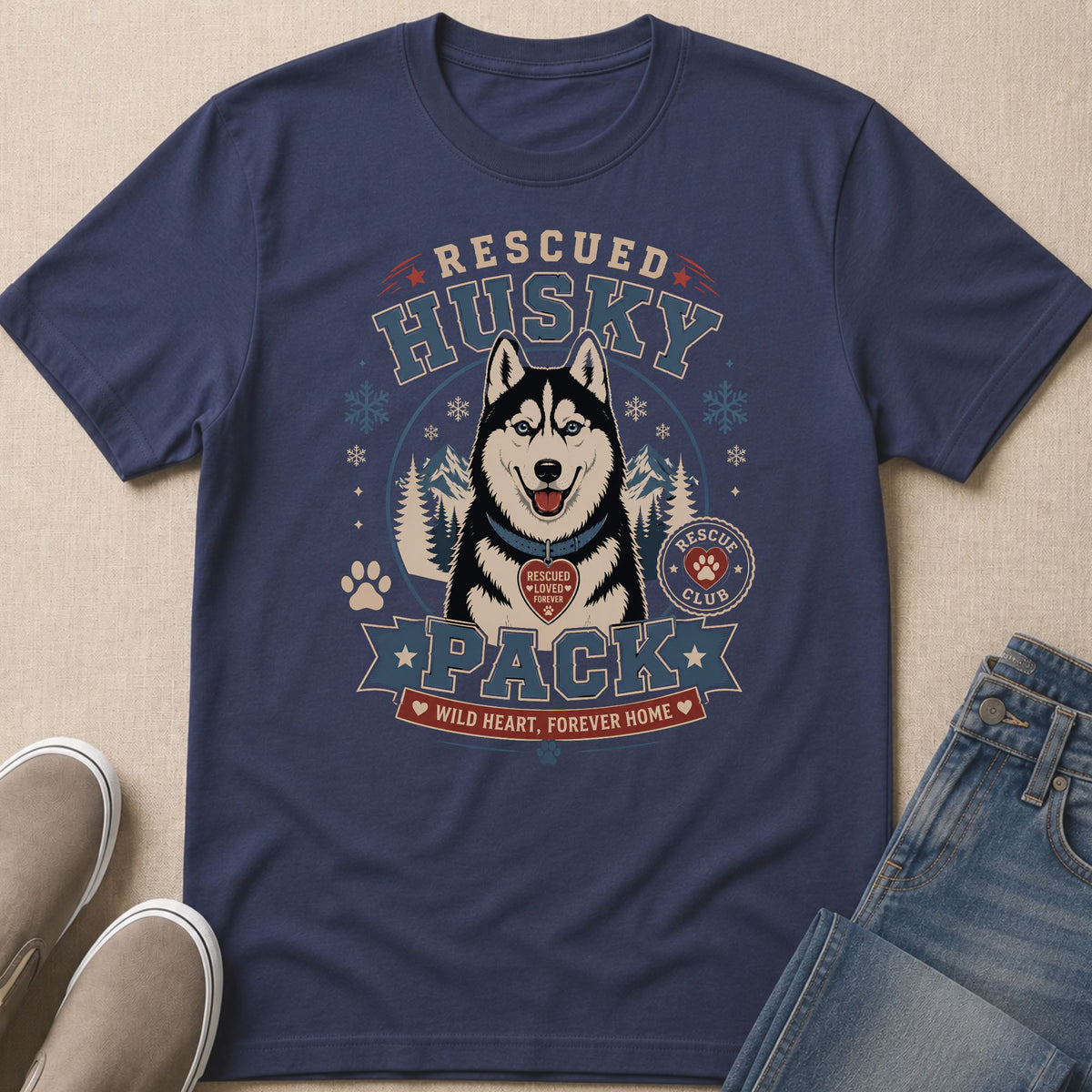 Dark blue t-shirt featuring a husky, mountains, and text "Rescued Husky Pack".