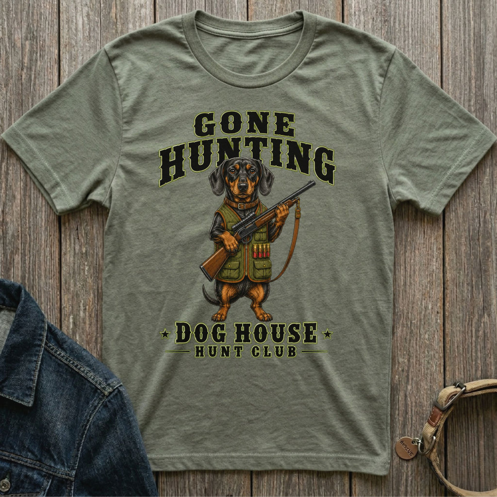 Green t-shirt with a dachshund holding a rifle, text "GONE HUNTING DOG HOUSE HUNT CLUB".