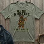 Green t-shirt with a dachshund holding a rifle, text "GONE HUNTING DOG HOUSE HUNT CLUB".