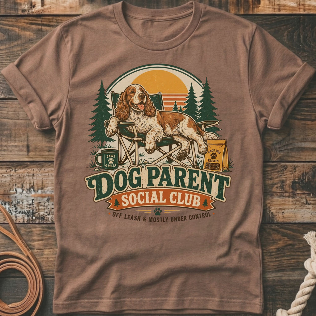 Dog Parent Social Club text with dog sitting in chair, trees, and sunset graphic.