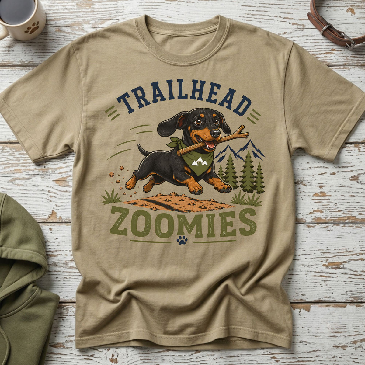 Dachshund with stick in mouth on t-shirt with text "TRAILHEAD ZOOMIES".