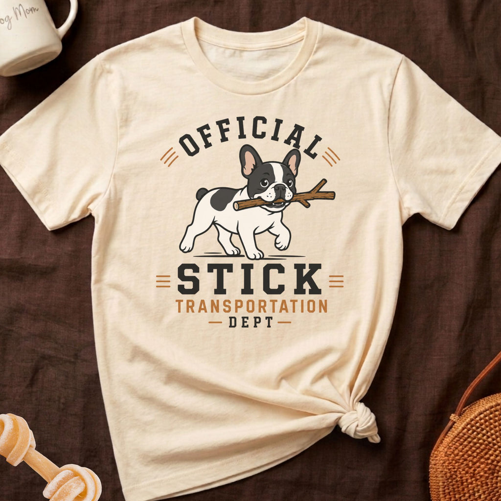 French bulldog carrying stick with text "Official Stick Transportation Dept".