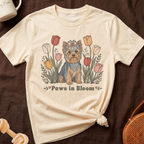 Cream t-shirt with a Yorkshire Terrier sitting among colorful tulips and the text "Paws in Bloom".