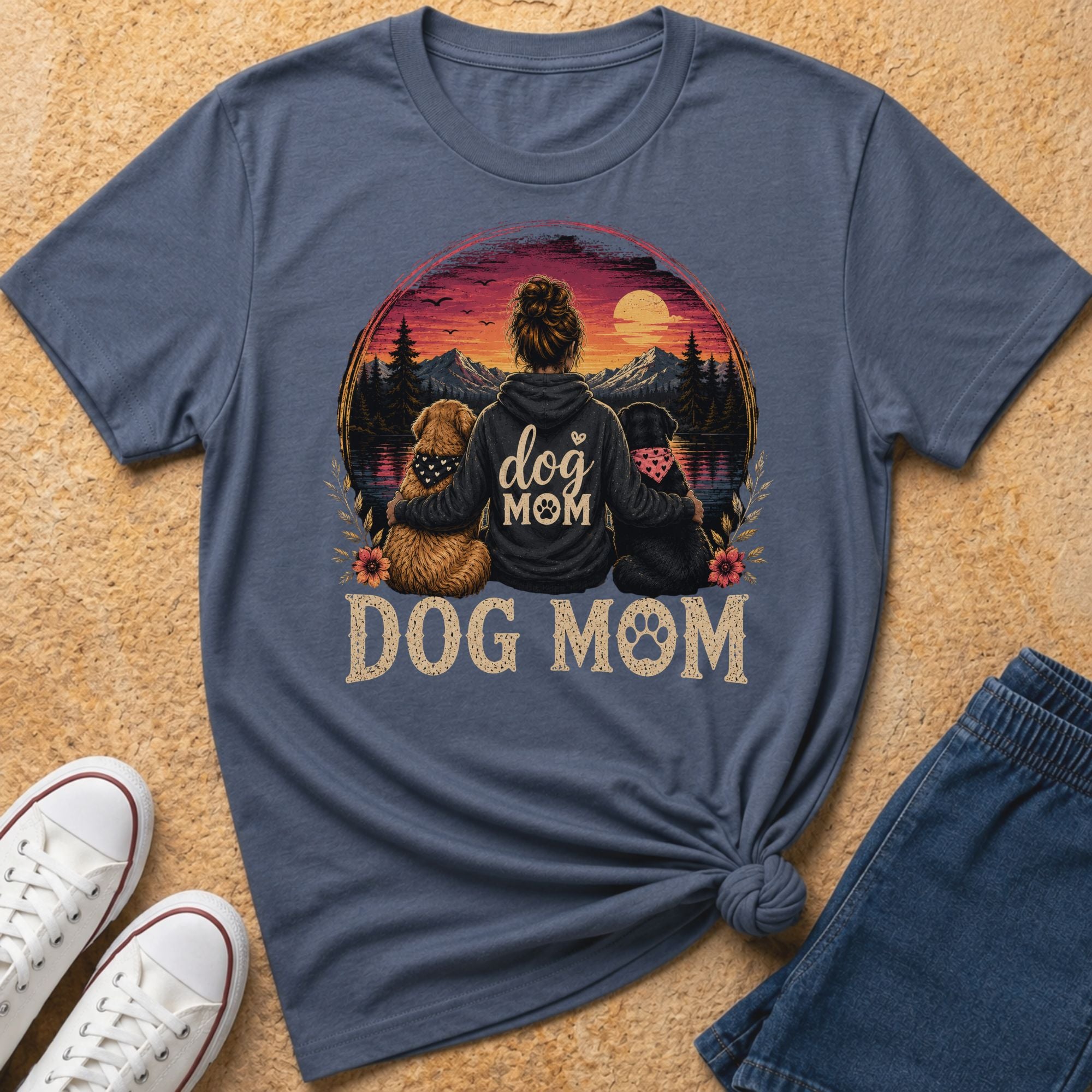 Blue t-shirt with "Dog Mom" text and sunset mountain scene with dogs.