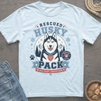 Light blue t-shirt graphic: Rescued Husky Pack with dog, mountains, and snowflakes.