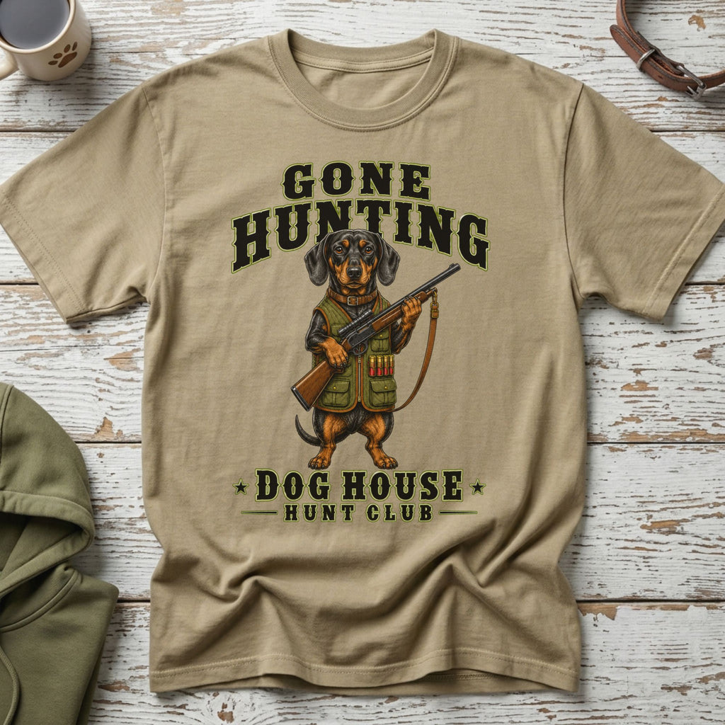 T-shirt with dachshund in hunting gear holding a rifle, text "Gone Hunting Dog House Hunt Club".