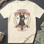Cream t-shirt with a Doberman illustration and text reading "Rescued Doberman Loyalty Club Adopted Protector."