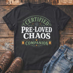 Black t-shirt with "Certified Pre-Loved Chaos Companion" text and paw print.