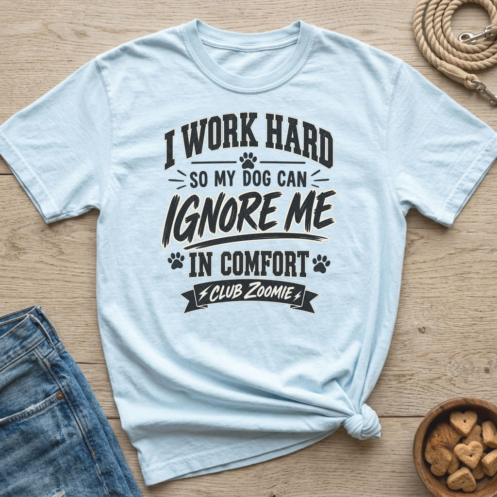Light blue t-shirt with text "I work hard so my dog can ignore me in comfort Club Zoomie".