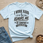Light blue t-shirt with text "I work hard so my dog can ignore me in comfort Club Zoomie".