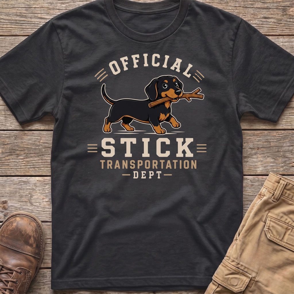 Dachshund with stick on shirt that says "Official Stick Transportation Dept"