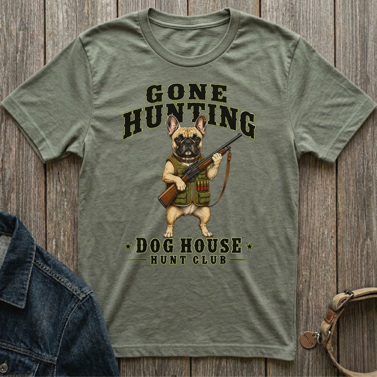 Green t-shirt with French bulldog holding a rifle and text "GONE HUNTING DOG HOUSE HUNT CLUB".
