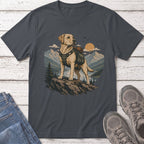Labrador retriever wearing a backpack stands on rocks overlooking a mountain lake scene.
