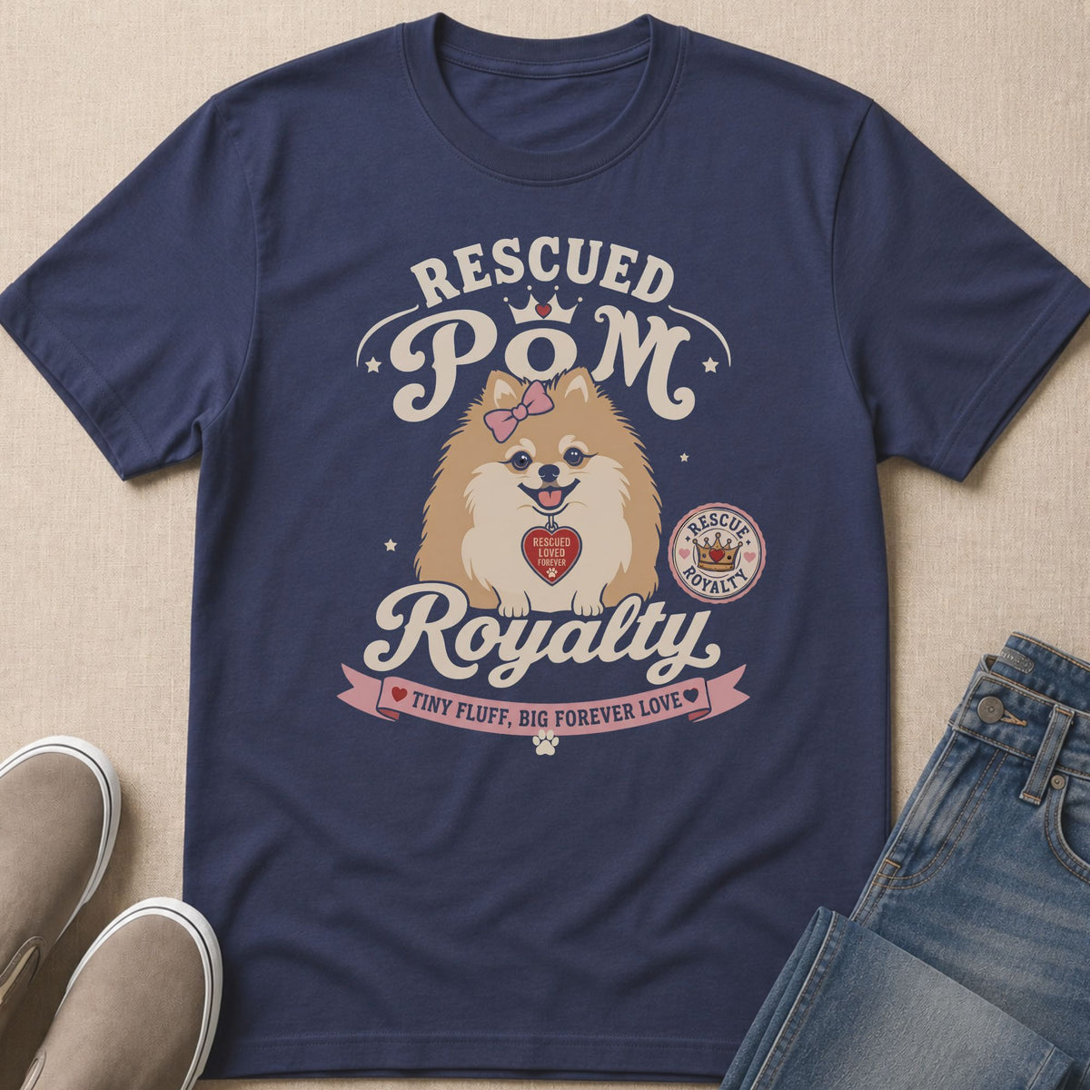 Navy t-shirt with graphic of a Pomeranian wearing a pink bow and a heart tag.