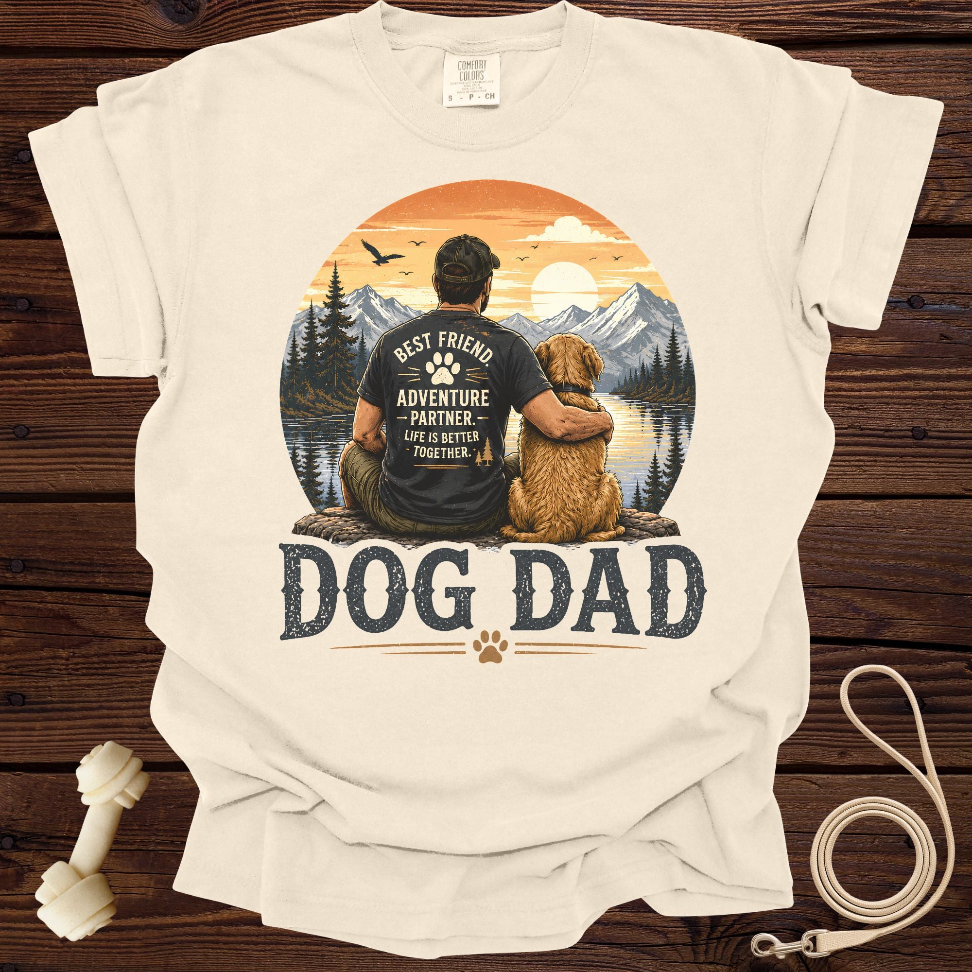 Cream t-shirt with "DOG DAD" text and a graphic of a man and dog in nature.