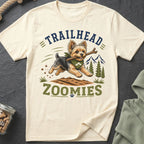 Yorkshire Terrier with stick on shirt reading "Trailhead Zoomies" with mountains.