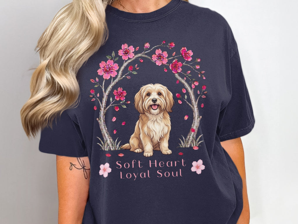 Dark navy t-shirt with a drawing of a fluffy dog surrounded by pink blossoms and text.