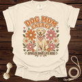 Cream t-shirt with retro design of a happy dog, flowers, and text "Dog Mom Energy" and "Spoiled Dogs Live Here".