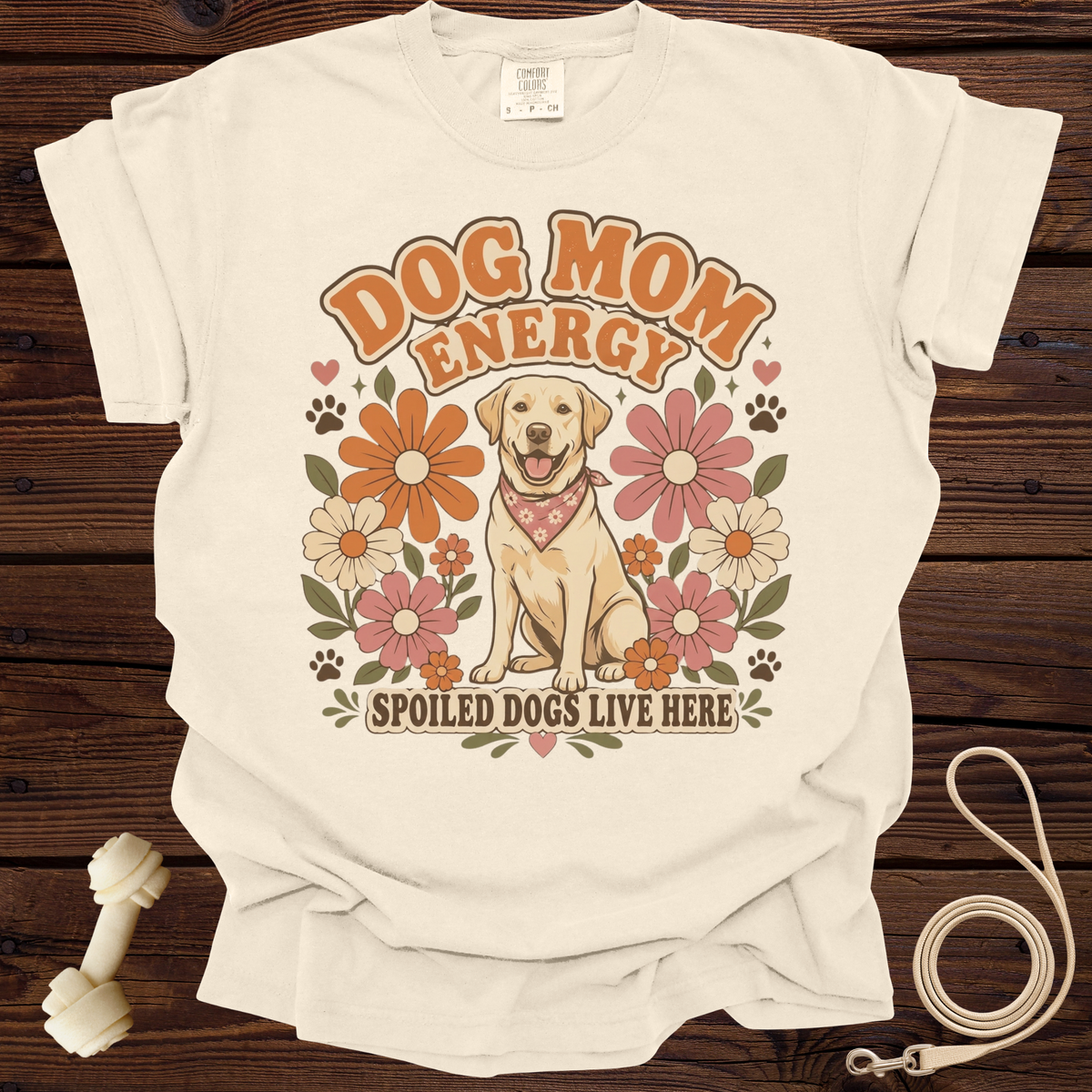 Cream t-shirt with retro design of a happy dog, flowers, and text "Dog Mom Energy" and "Spoiled Dogs Live Here".