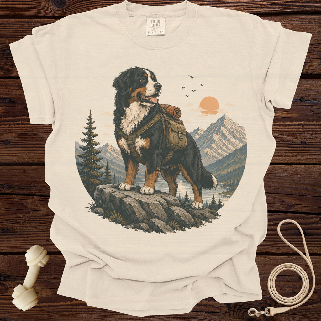 Bernese Mountain Dog wearing a backpack in a mountain landscape on a cream t-shirt.