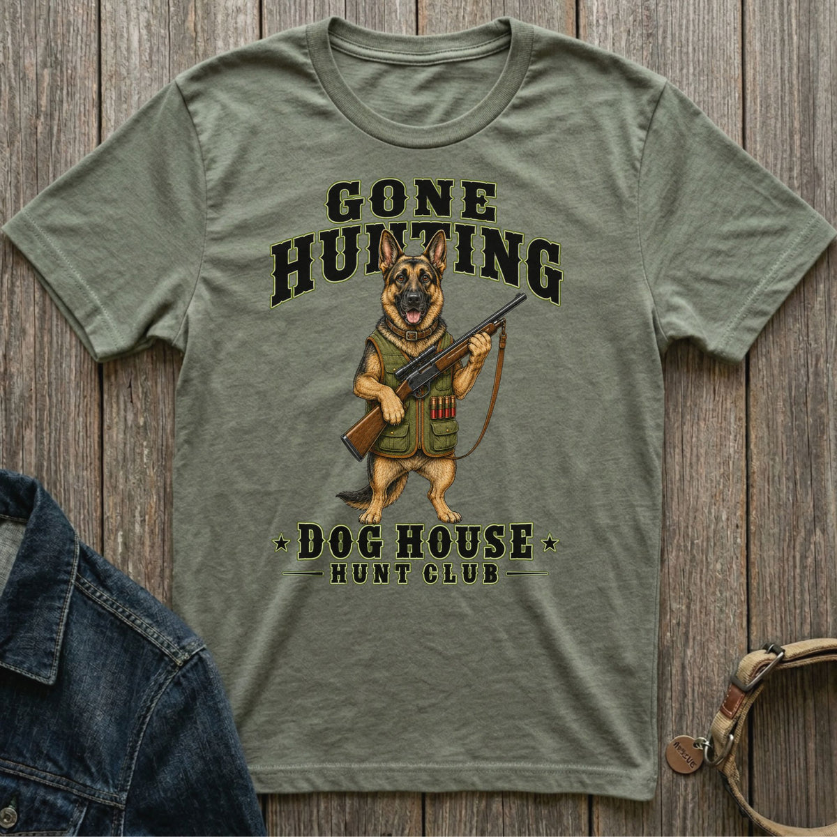 Green t-shirt with German Shepherd graphic holding rifle, text reads "GONE HUNTING DOG HOUSE HUNT CLUB".