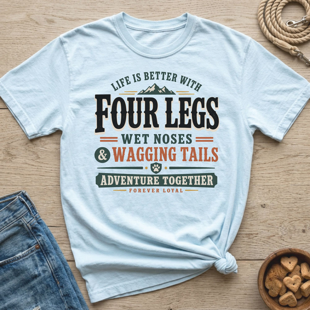 Light blue t-shirt with text "Life is better with Four Legs, Wet Noses & Wagging Tails".