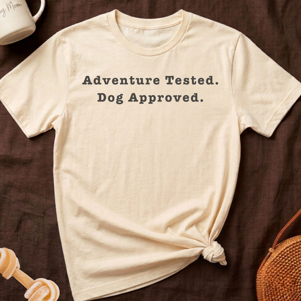 Cream t-shirt with "Adventure Tested. Dog Approved." text, tied knot at bottom.