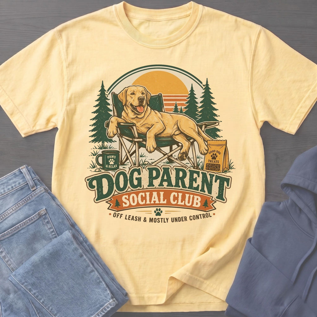Yellow t-shirt with a labrador relaxing in a chair and "Dog Parent Social Club" text.