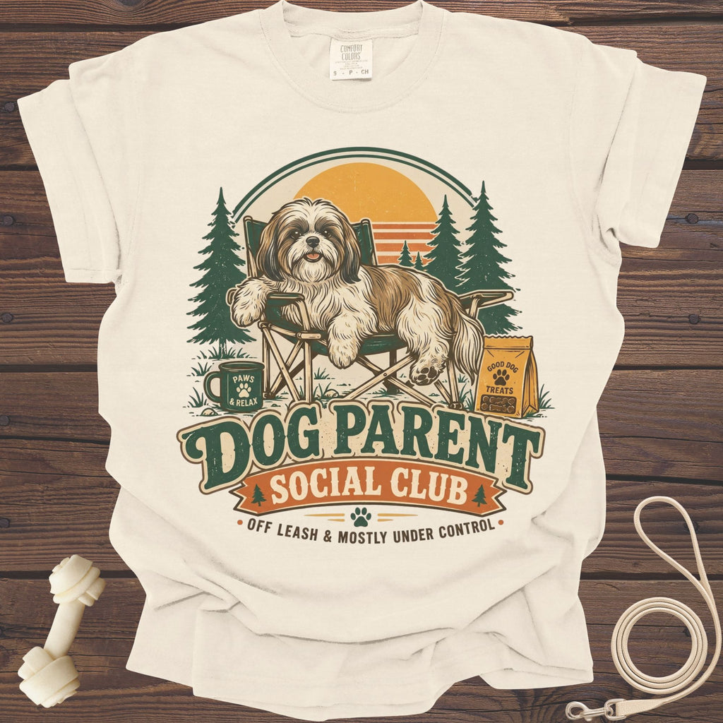 Shih Tzu on camping chair with "Dog Parent Social Club" text and dog accessories.